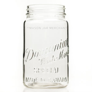 Vintage wide mouth quart mason jar with Dominion Special logo, against a white background 