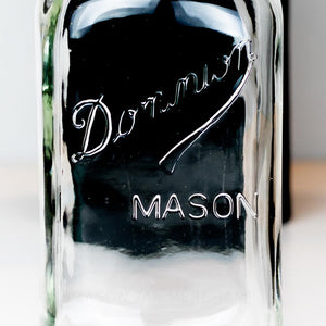 Close-up of Dominion Mason logo on a regular mouth quart mason jar