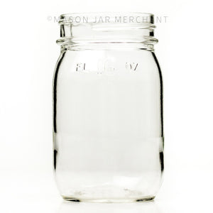 Vintage regular mouth pint mason jar with FL 16 oz imprinted near the rim, against a white background 